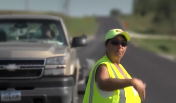 Flagger waving car through