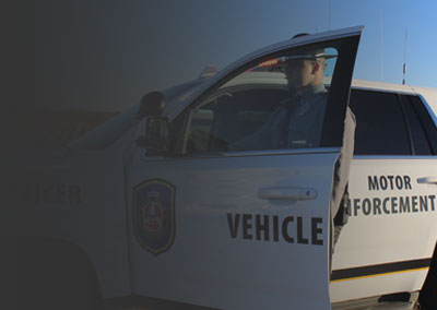 photo of MVE officers standing in front of their vehicle