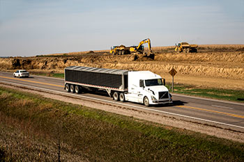 Semi driving by highway work